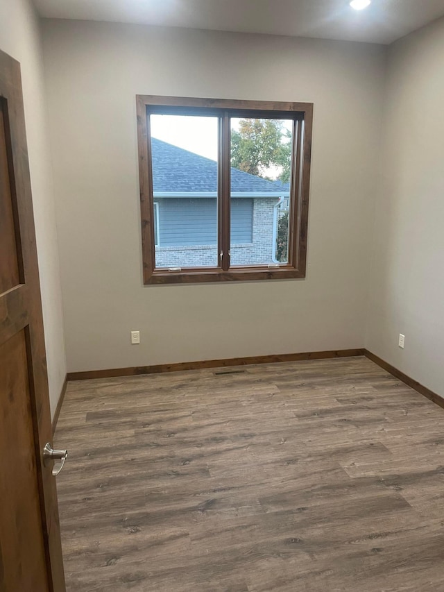 spare room with hardwood / wood-style floors