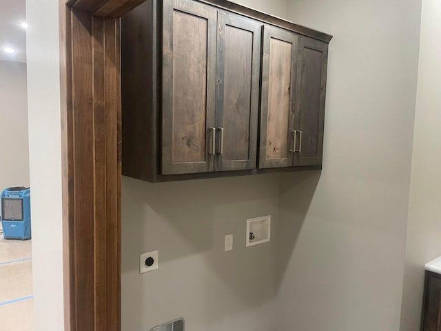 washroom with cabinets, washer hookup, and hookup for an electric dryer