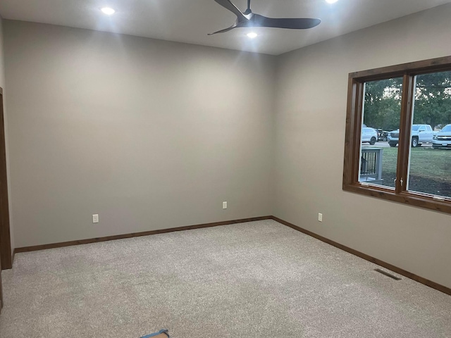 unfurnished room with ceiling fan and carpet floors