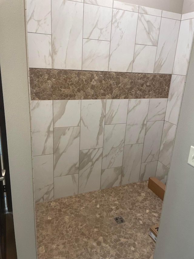 bathroom with tiled shower