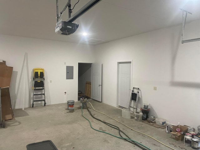 garage with a garage door opener and electric panel