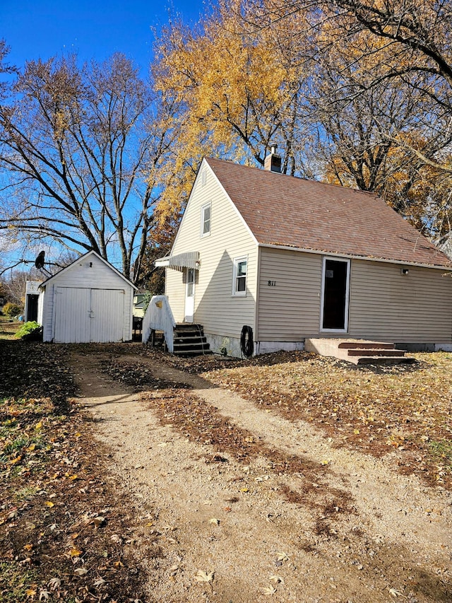 view of home's exterior featuring an outbuilding