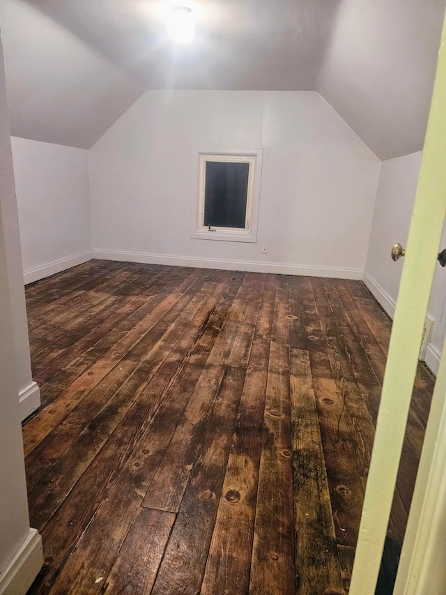 additional living space featuring dark hardwood / wood-style floors and vaulted ceiling