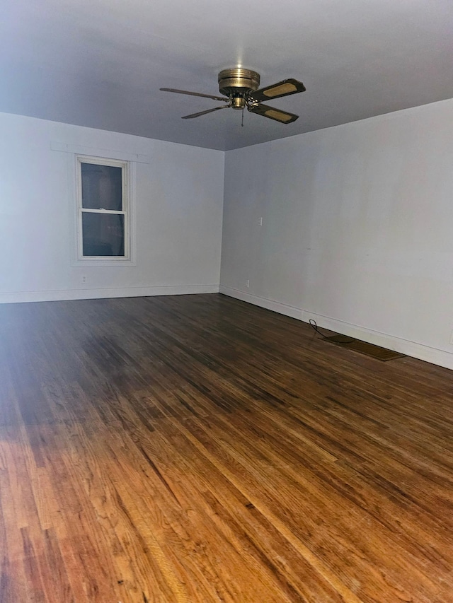 unfurnished room with ceiling fan and dark hardwood / wood-style flooring