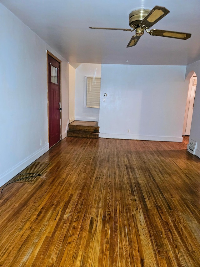 unfurnished living room featuring dark hardwood / wood-style floors and ceiling fan