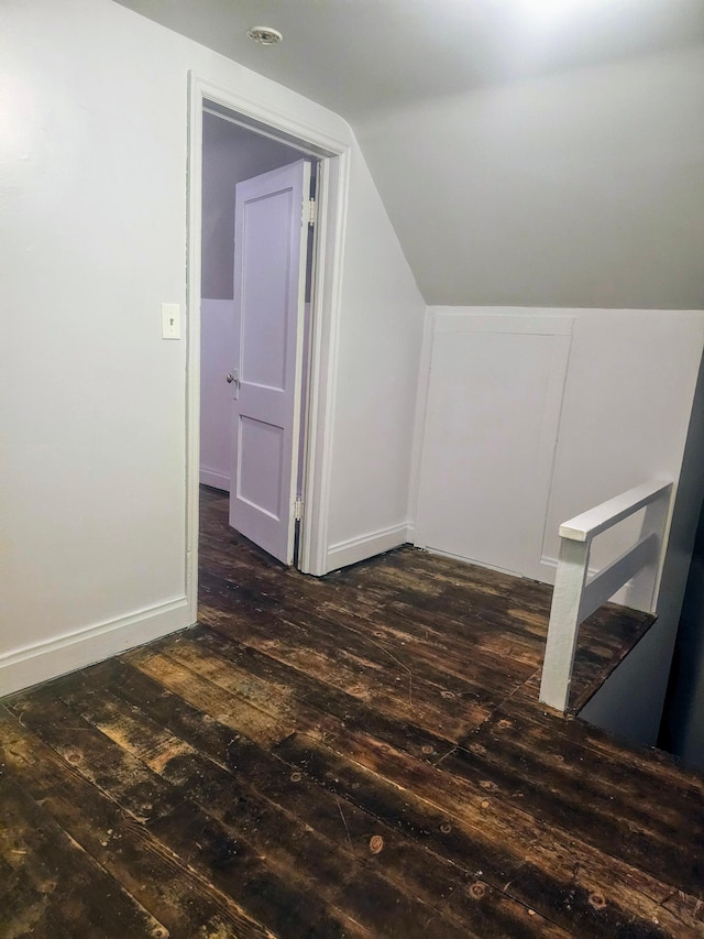 additional living space featuring dark hardwood / wood-style flooring and lofted ceiling