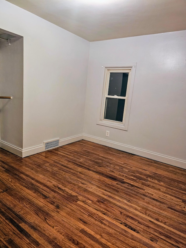 unfurnished room featuring dark hardwood / wood-style flooring