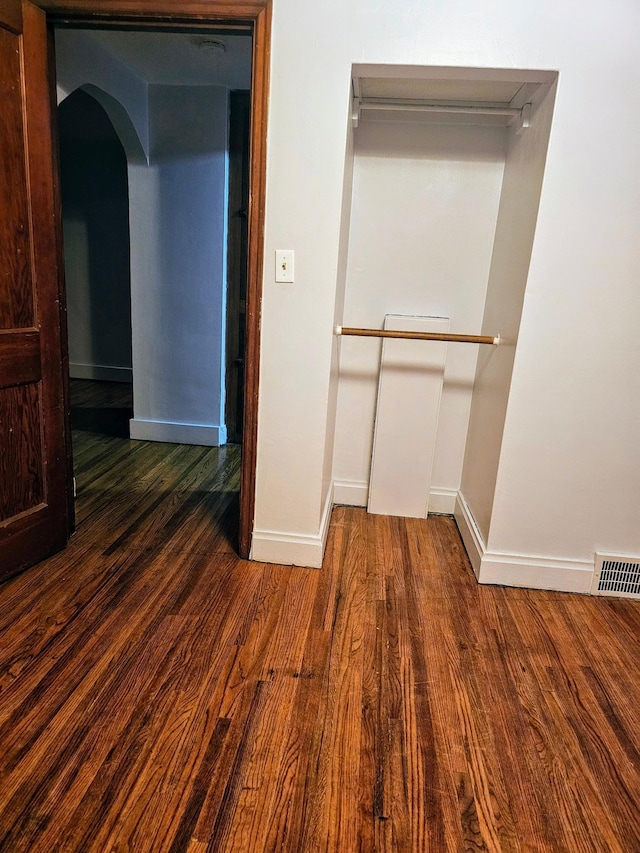 hallway featuring dark hardwood / wood-style flooring