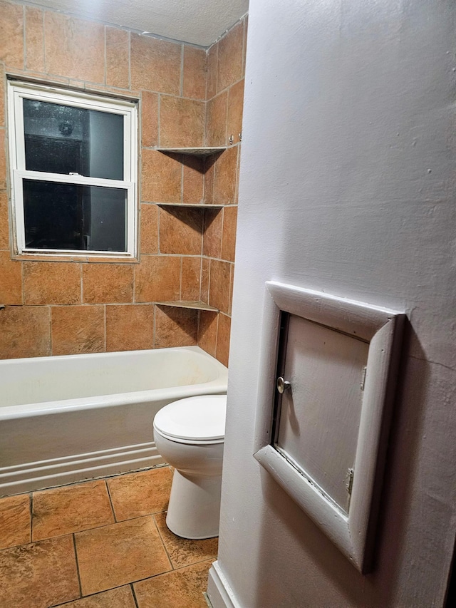 bathroom with toilet and a textured ceiling