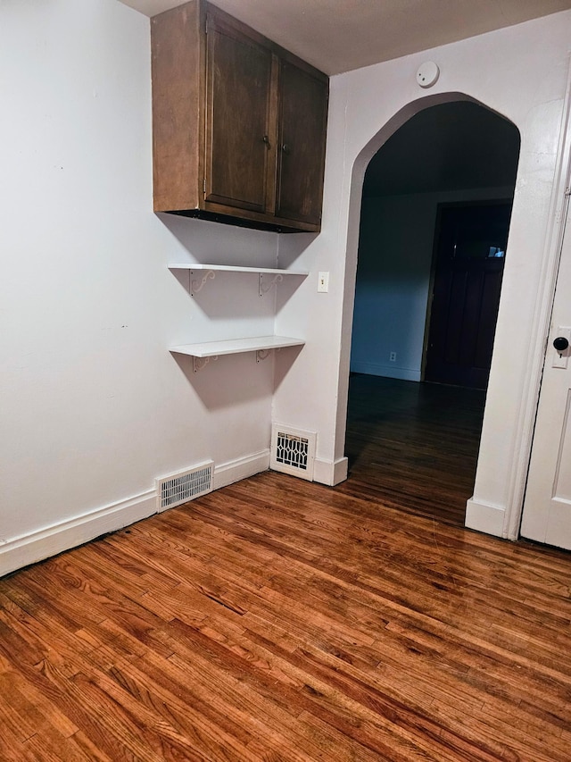 empty room with dark hardwood / wood-style floors