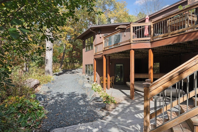 6517 Crackleberry Trl, Woodbury, MN 55129 - view of side of home with a wooden deck and a patio
