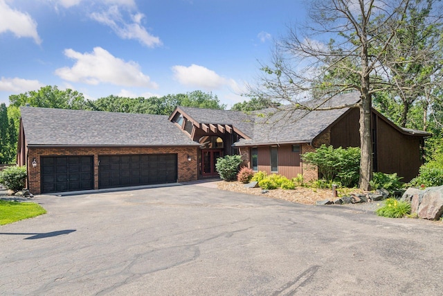6517 Crackleberry Trl, Woodbury, MN 55129 - view of front facade with driveway, an attached garage, and brick siding