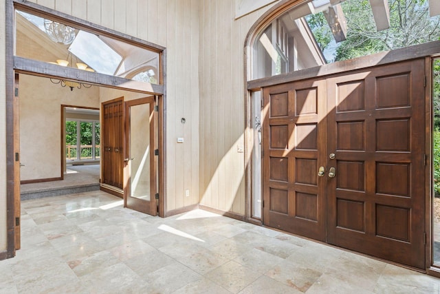 6517 Crackleberry Trl, Woodbury, MN 55129 - entryway featuring a high ceiling and wood walls