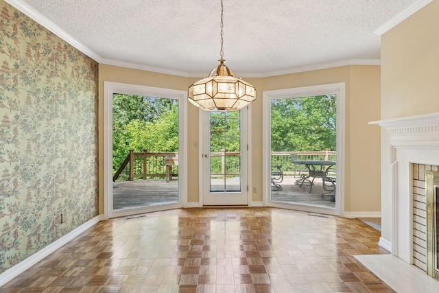 6517 Crackleberry Trl, Woodbury, MN 55129 - unfurnished dining area featuring healthy amount of natural light, a textured ceiling, a fireplace with flush hearth, wallpapered walls, and ornamental molding