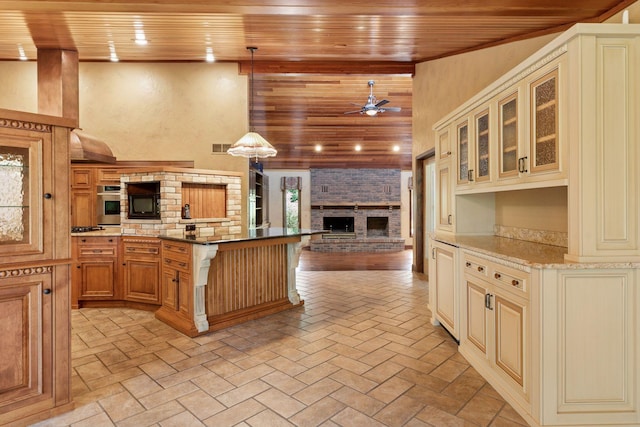 6517 Crackleberry Trl, Woodbury, MN 55129 - kitchen featuring wooden ceiling, open floor plan, cream cabinetry, ceiling fan, and stainless steel oven