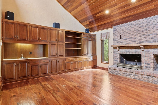 6517 Crackleberry Trl, Woodbury, MN 55129 - unfurnished living room with lofted ceiling, wood ceiling, light wood finished floors, and a brick fireplace