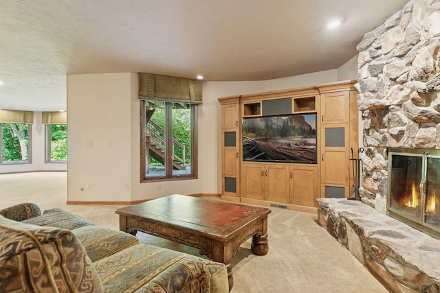 6517 Crackleberry Trl, Woodbury, MN 55129 - living room featuring light colored carpet, a stone fireplace, plenty of natural light, and recessed lighting