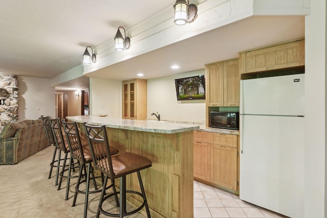 6517 Crackleberry Trl, Woodbury, MN 55129 - kitchen with freestanding refrigerator, black microwave, light brown cabinetry, and a kitchen breakfast bar