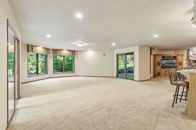6517 Crackleberry Trl, Woodbury, MN 55129 - unfurnished living room with light colored carpet and recessed lighting