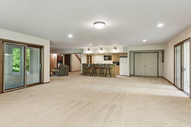 6517 Crackleberry Trl, Woodbury, MN 55129 - living room featuring light carpet, recessed lighting, and bar
