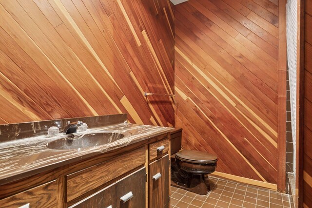 6517 Crackleberry Trl, Woodbury, MN 55129 - bathroom featuring vanity, wooden walls, and tile patterned floors