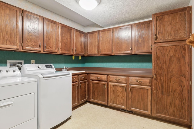 6517 Crackleberry Trl, Woodbury, MN 55129 - laundry area with cabinet space, washing machine and clothes dryer, and a textured ceiling