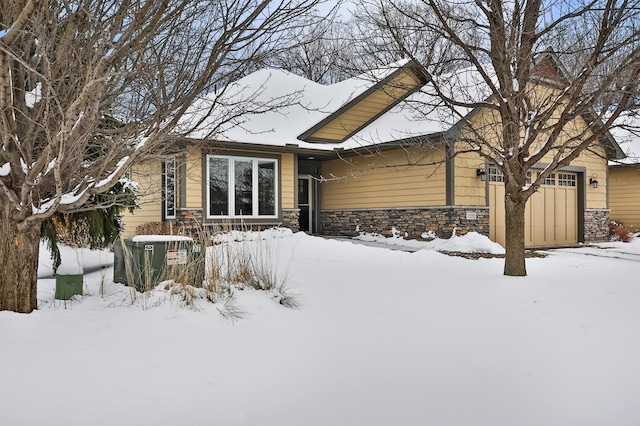 snow covered property featuring a garage