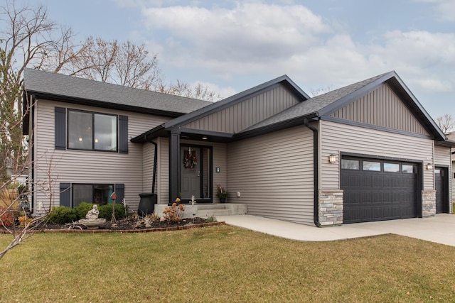 view of front of property with a front yard and a garage