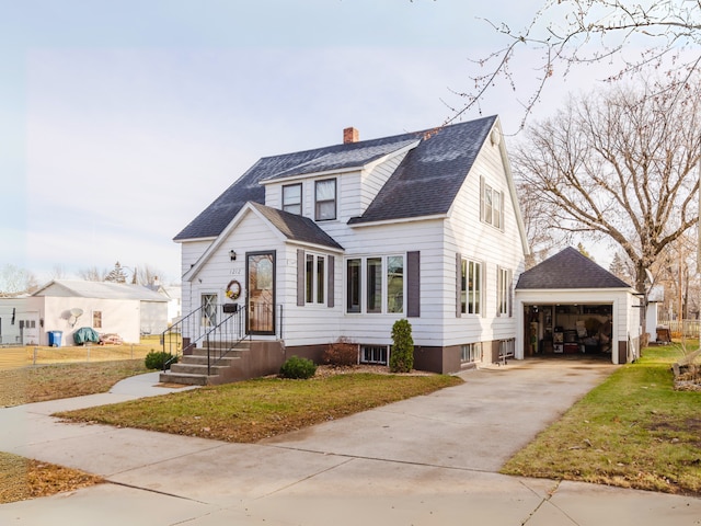 view of front facade with a garage, an outdoor structure, and a front lawn