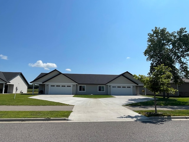 single story home with a front yard and a garage