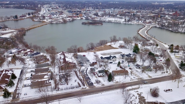 snowy aerial view with a water view