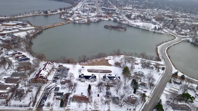 snowy aerial view with a water view