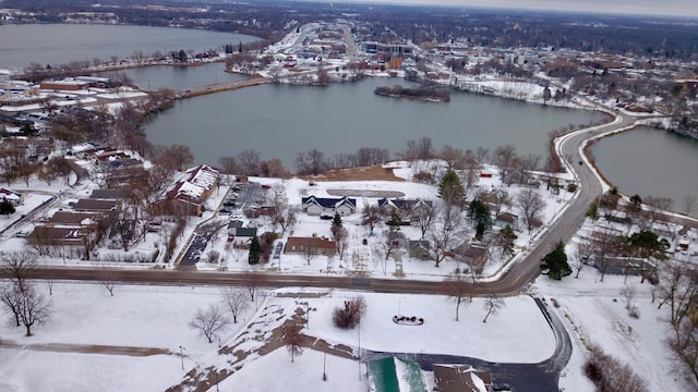 snowy aerial view featuring a water view