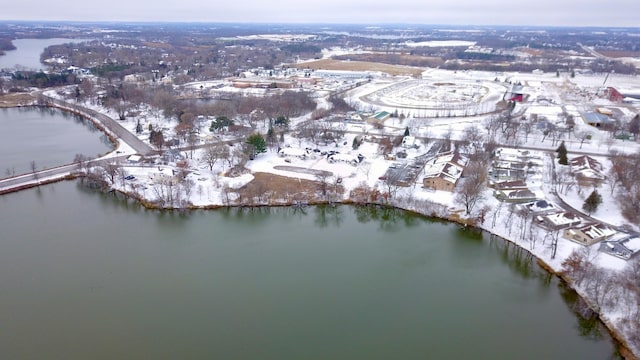 snowy aerial view with a water view