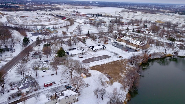 snowy aerial view featuring a water view