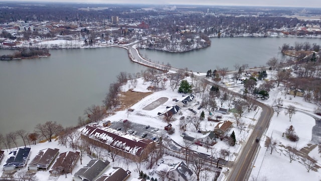 snowy aerial view featuring a water view