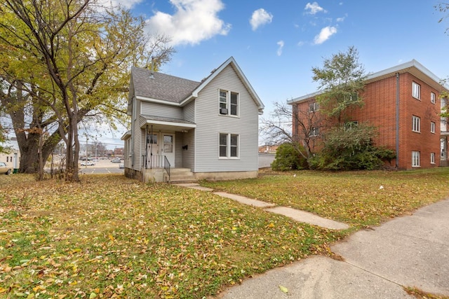 view of property featuring a front lawn