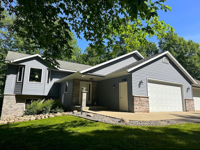 view of front of property featuring a garage and a front lawn