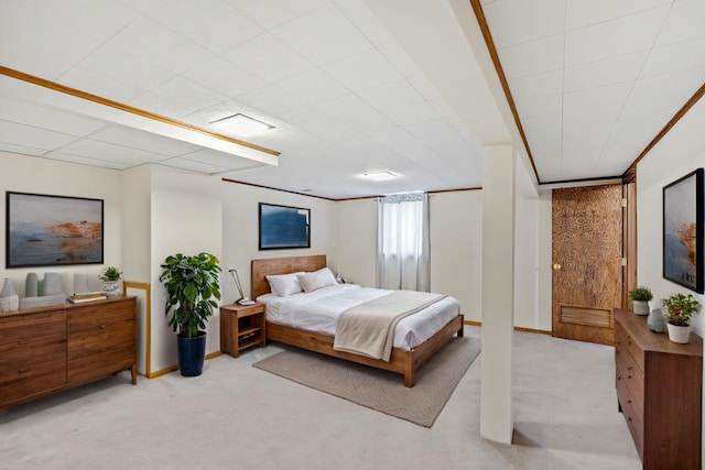 bedroom featuring light colored carpet and baseboards