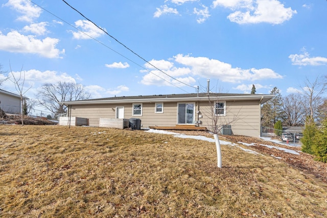 back of property featuring cooling unit, a lawn, and fence