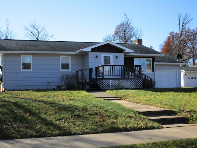 single story home featuring a front lawn and a garage