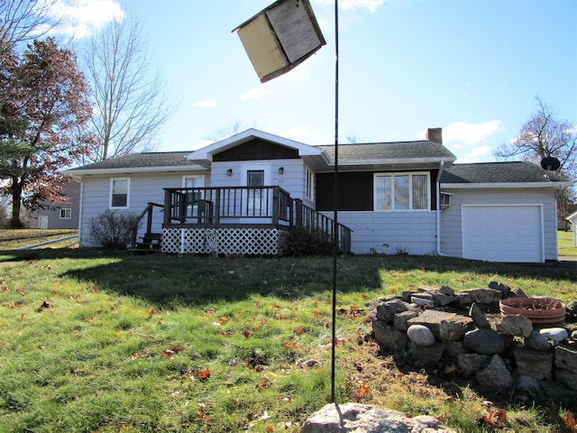 view of front of home with a garage, a front lawn, and a deck