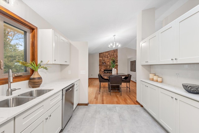 kitchen featuring lofted ceiling, white cabinets, sink, light hardwood / wood-style flooring, and stainless steel dishwasher