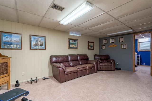 carpeted living room featuring a paneled ceiling