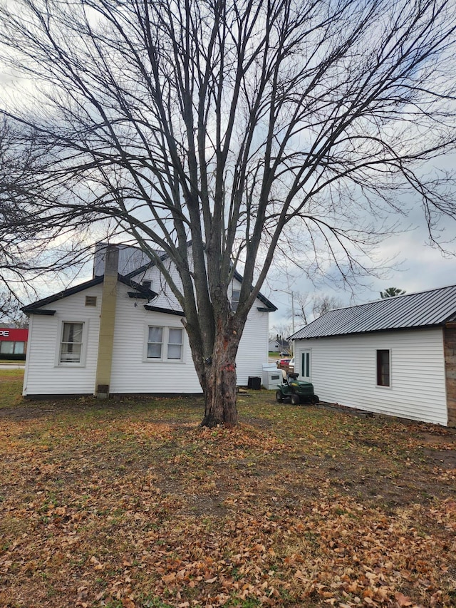 view of side of home featuring an outbuilding