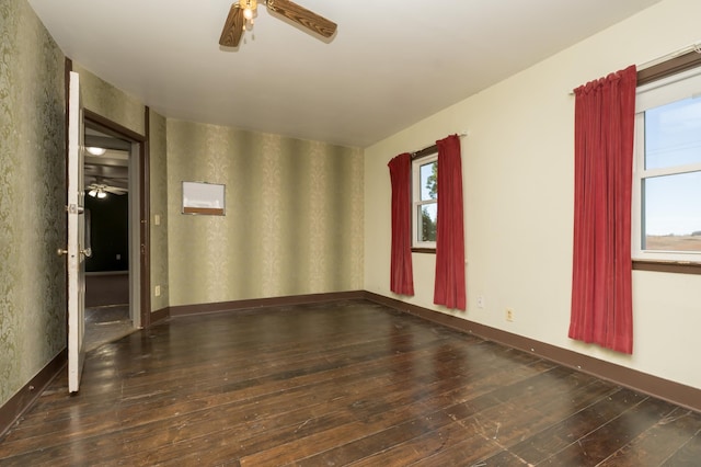 empty room with dark wood-type flooring and ceiling fan