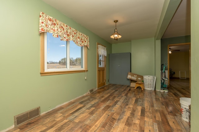 unfurnished dining area featuring dark hardwood / wood-style floors