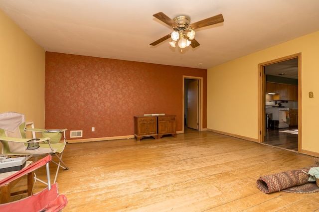 interior space with hardwood / wood-style flooring and ceiling fan