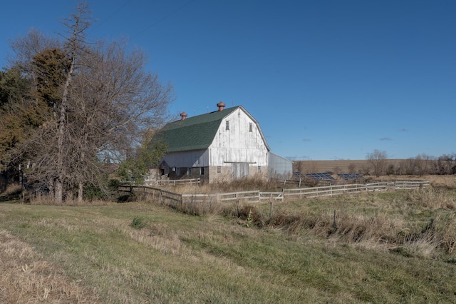 view of yard with a rural view and an outbuilding