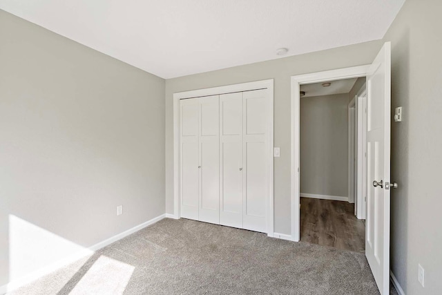 unfurnished bedroom with carpet and a closet